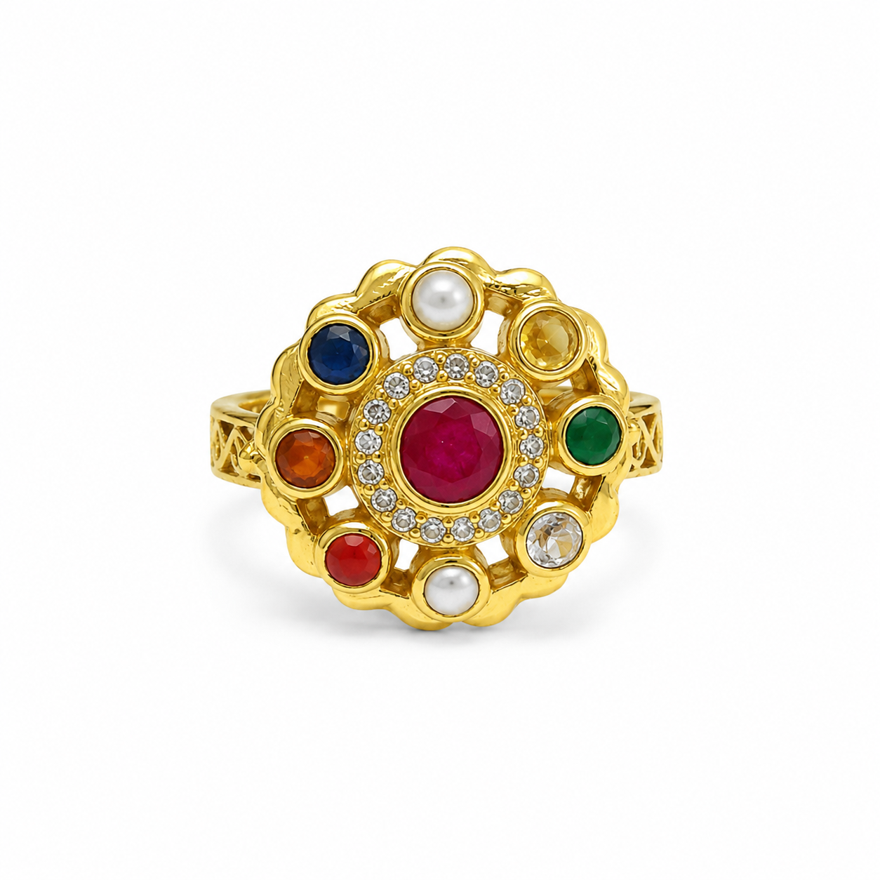 A gold ring with a multi-colored floral cluster setting, featuring a central red ruby, a surrounding halo of small clear stones, and accents of blue, green, orange, red, and white pearls, shown on a plain white background.